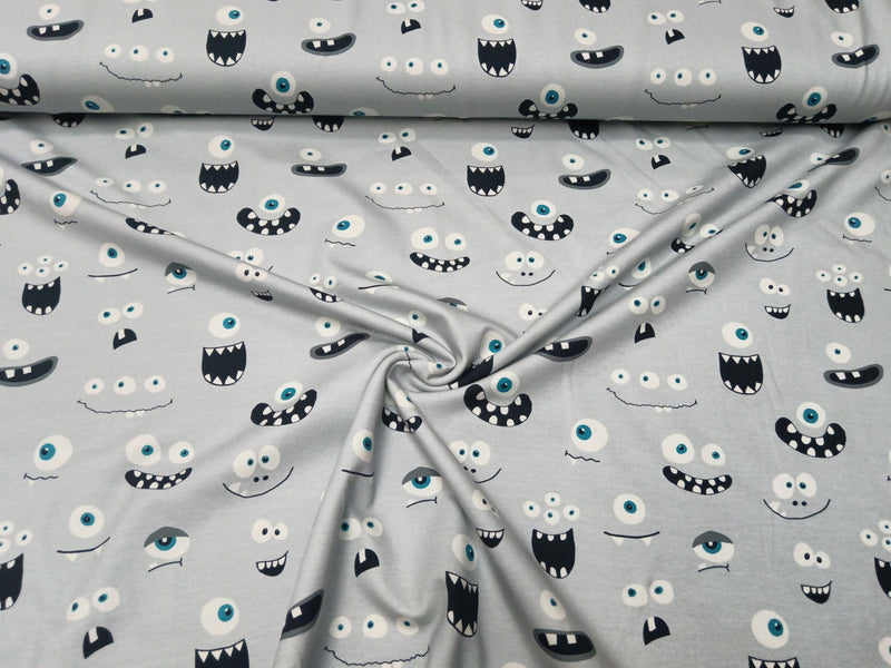 Baumwolljersey in hellgrau mit Monstergesichtern - Modemeter Stoffmarkt