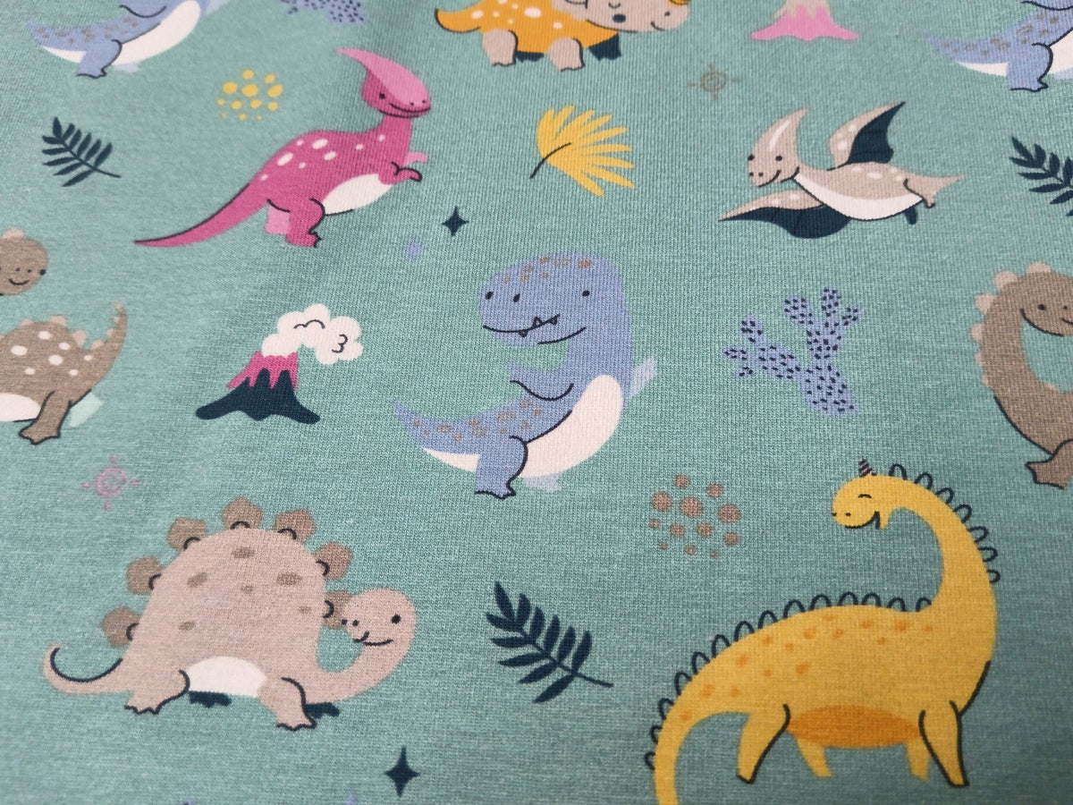 So niedlich - Baumwoll Jersey für Kinder in seegrün mit bunten Dinos - Modemeter Stoffmarkt