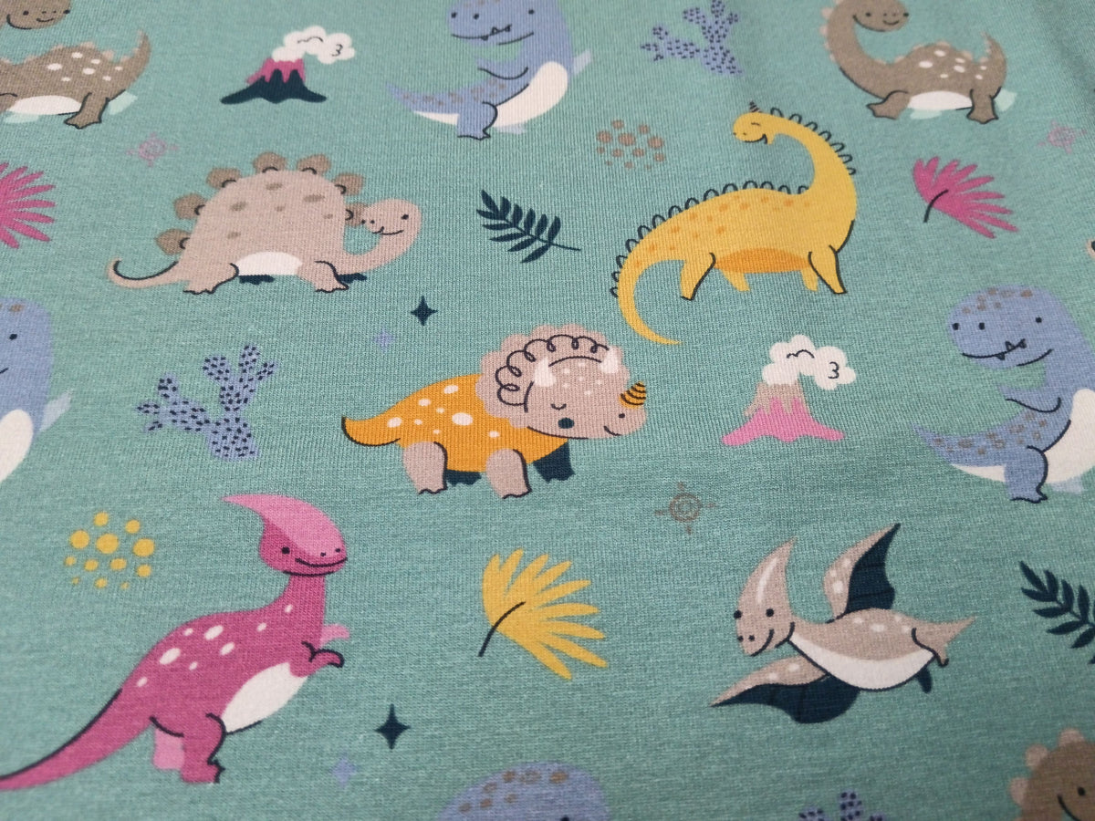 So niedlich - Baumwoll Jersey für Kinder in seegrün mit bunten Dinos - Modemeter Stoffmarkt