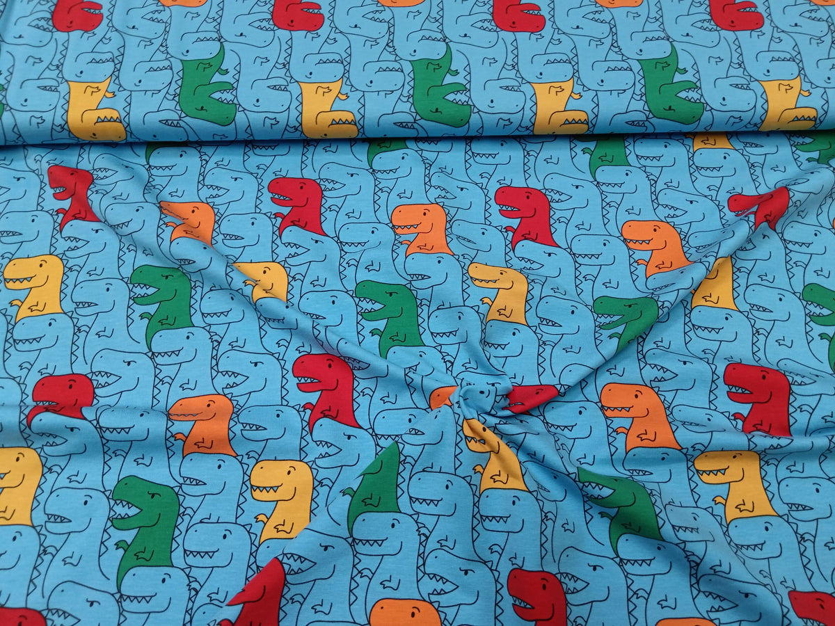 Kinderjersey in blau aus Baumwolle mit bunten Dino Karikaturen - Modemeter Stoffmarkt
