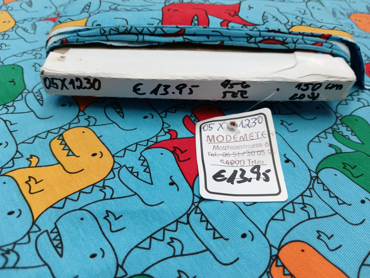 Kinderjersey in blau aus Baumwolle mit bunten Dino Karikaturen - Modemeter Stoffmarkt