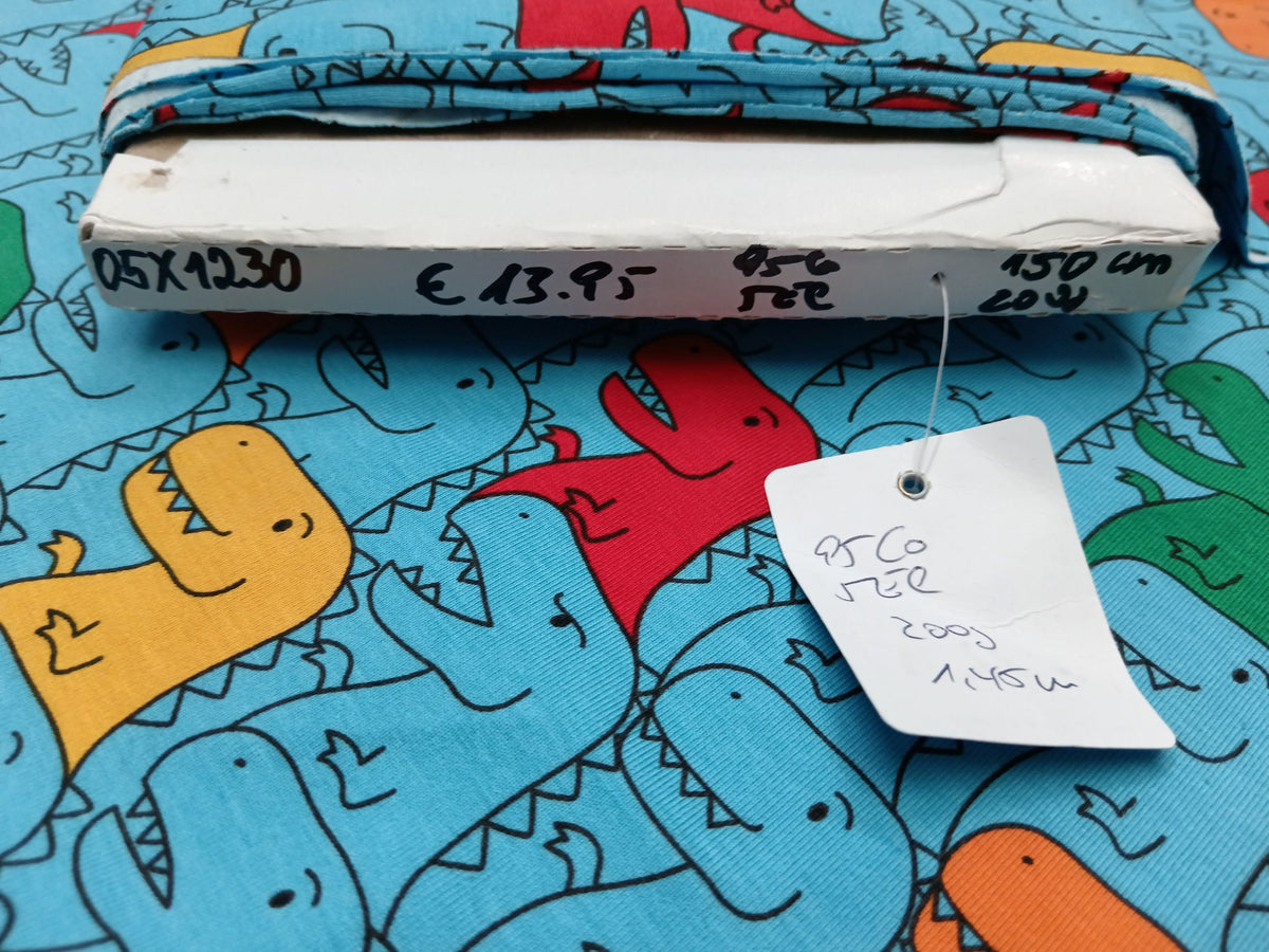 Kinderjersey in blau aus Baumwolle mit bunten Dino Karikaturen - Modemeter Stoffmarkt