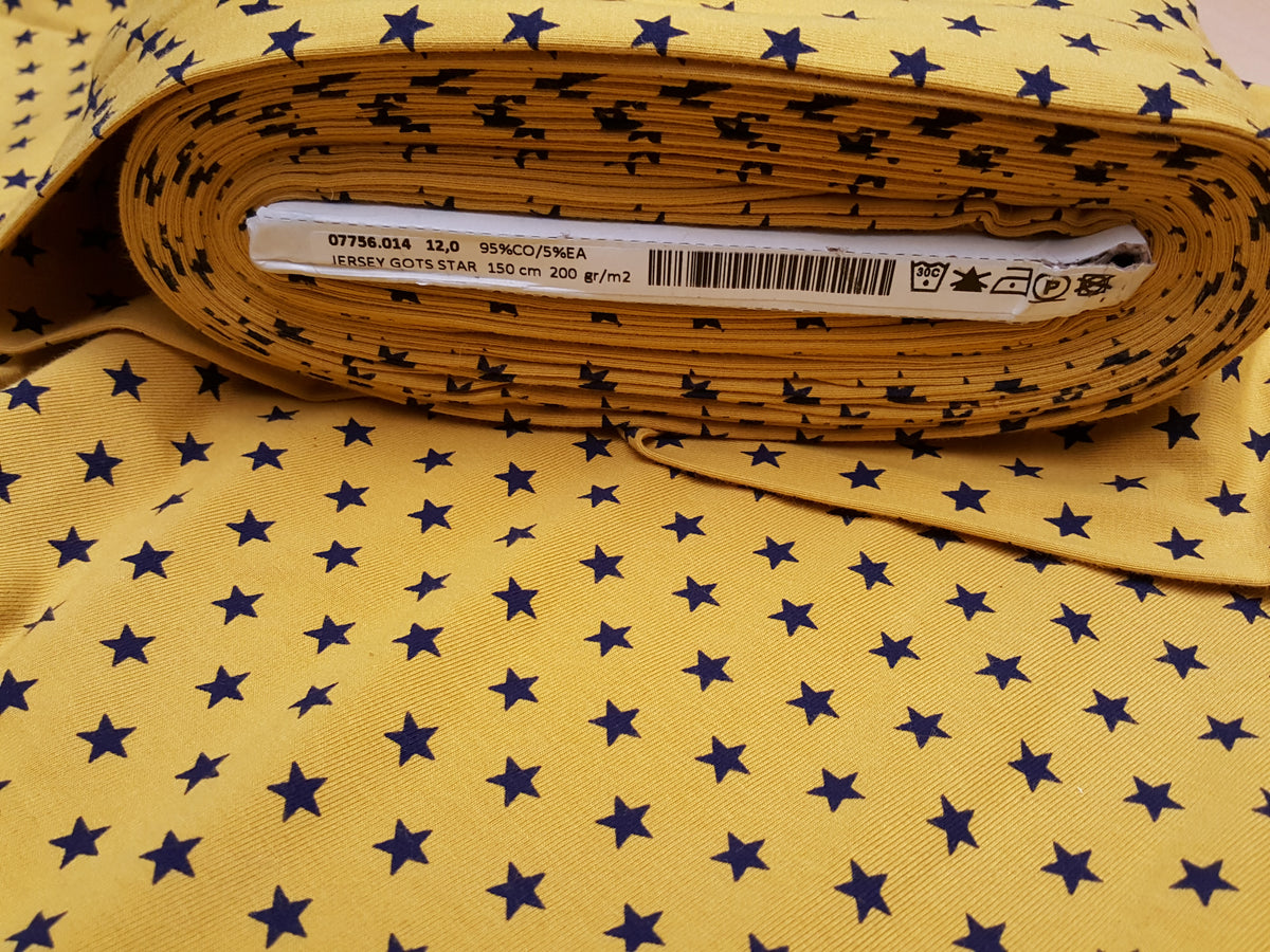 Organischer Baumwoll Jersey GOTS in senfgelb mit dunkelblauen Sternen - Modemeter Stoffmarkt Trier   modemeter.de